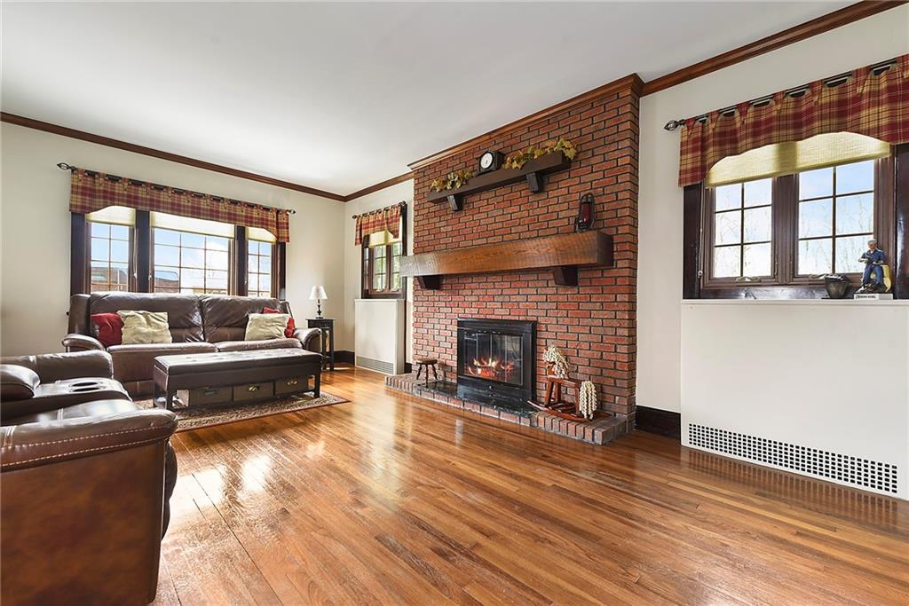 637 East McMurray Road Canonsburg, PA 15317 - Photo 8 of 50 Warm and inviting family room with gleaming hardwood floors, abundant natural light, and a beautiful brick fireplace as the focal point.