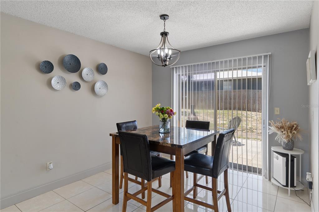 5025 Bromley Avenue Spring Hill, FL 34609 - Photo 11 of 41 a view of a dining room with furniture and chandelier