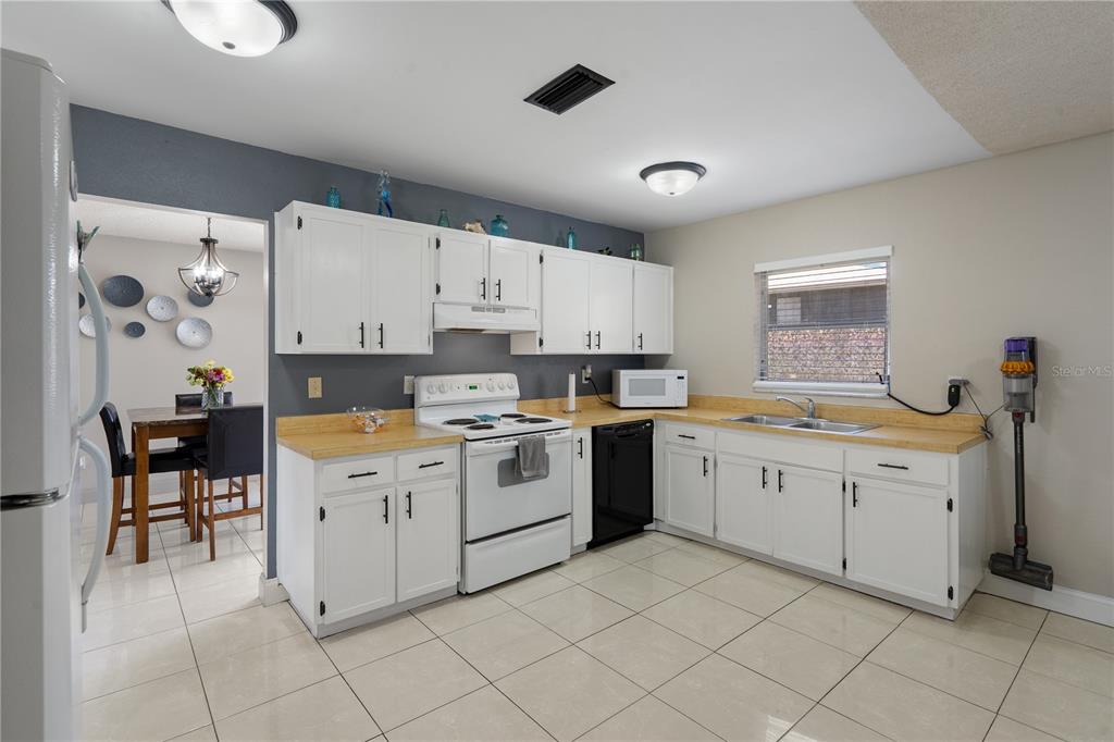 5025 Bromley Avenue Spring Hill, FL 34609 - Photo 12 of 41 a kitchen with cabinets appliances and a window