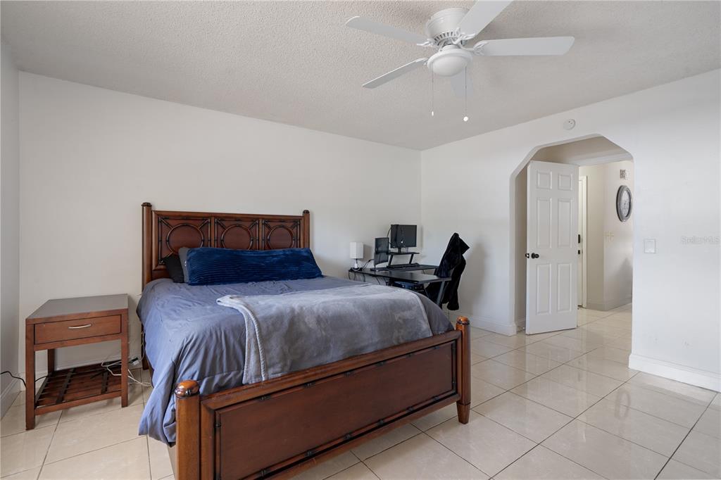 5025 Bromley Avenue Spring Hill, FL 34609 - Photo 26 of 41 a bedroom with a bed and a chandelier