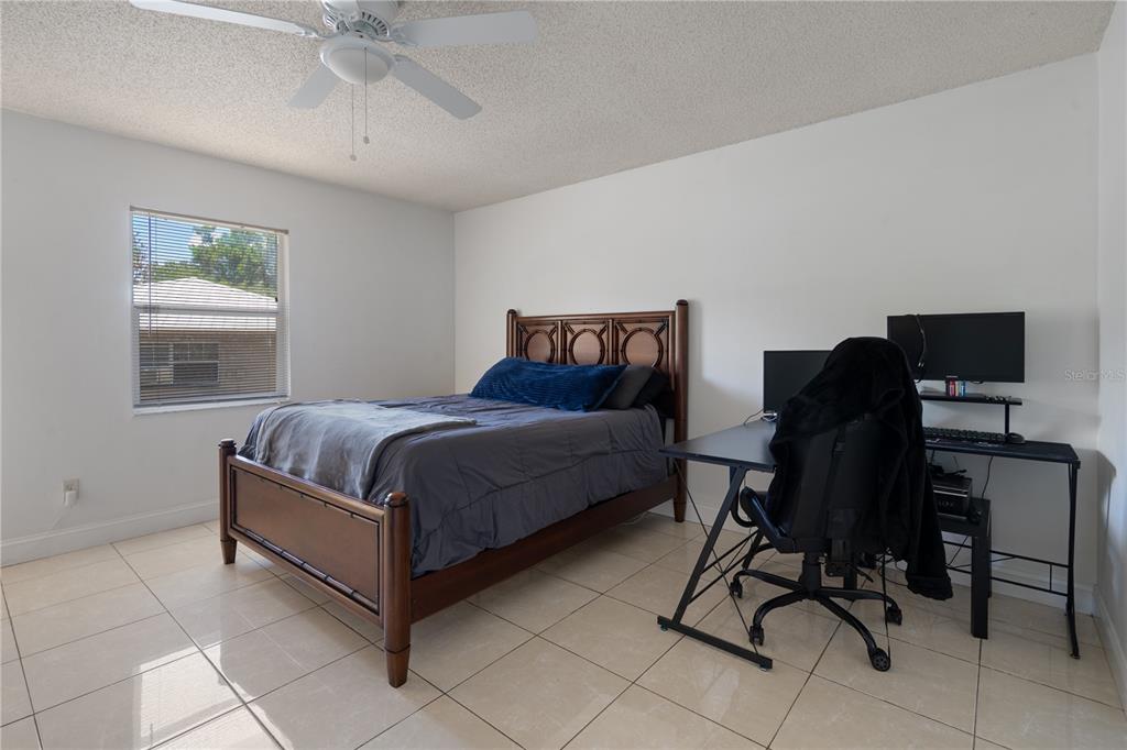 5025 Bromley Avenue Spring Hill, FL 34609 - Photo 27 of 41 a bedroom with a bed chair and a window