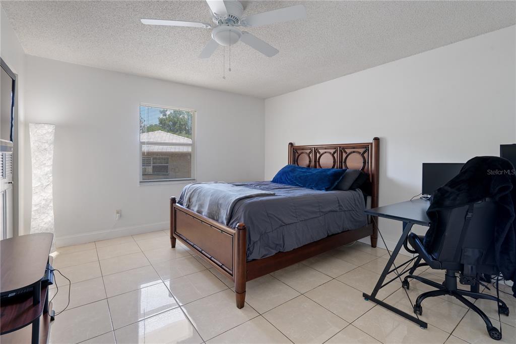 5025 Bromley Avenue Spring Hill, FL 34609 - Photo 28 of 41 a bedroom with a bed chair and window