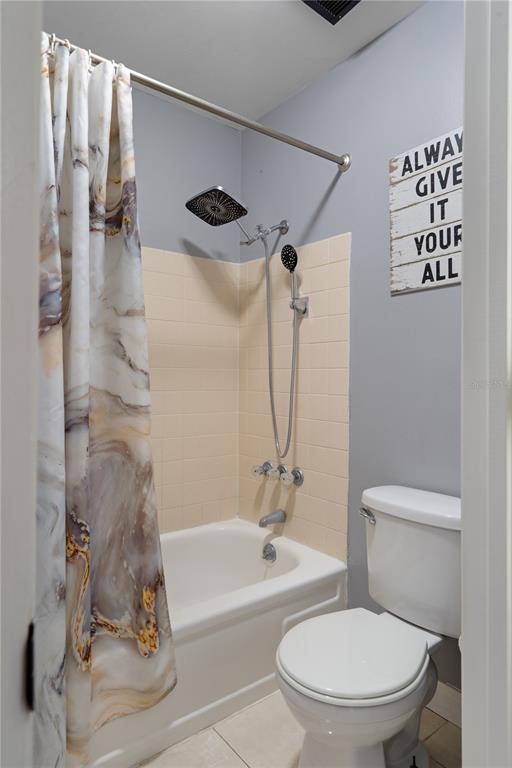 5025 Bromley Avenue Spring Hill, FL 34609 - Photo 31 of 41 a white toilet sitting next to a bath tub and a shower