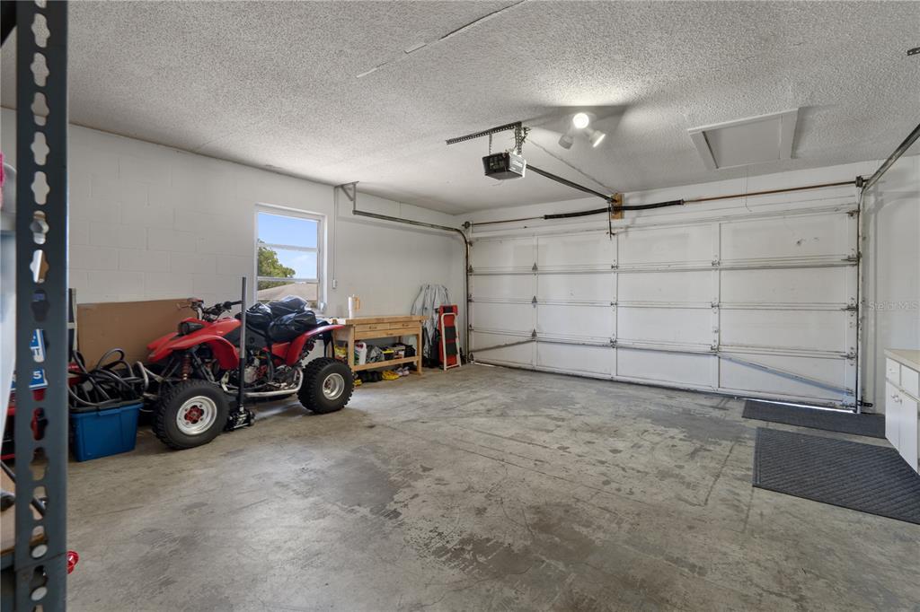 5025 Bromley Avenue Spring Hill, FL 34609 - Photo 34 of 41 a view of a garage with parked cars