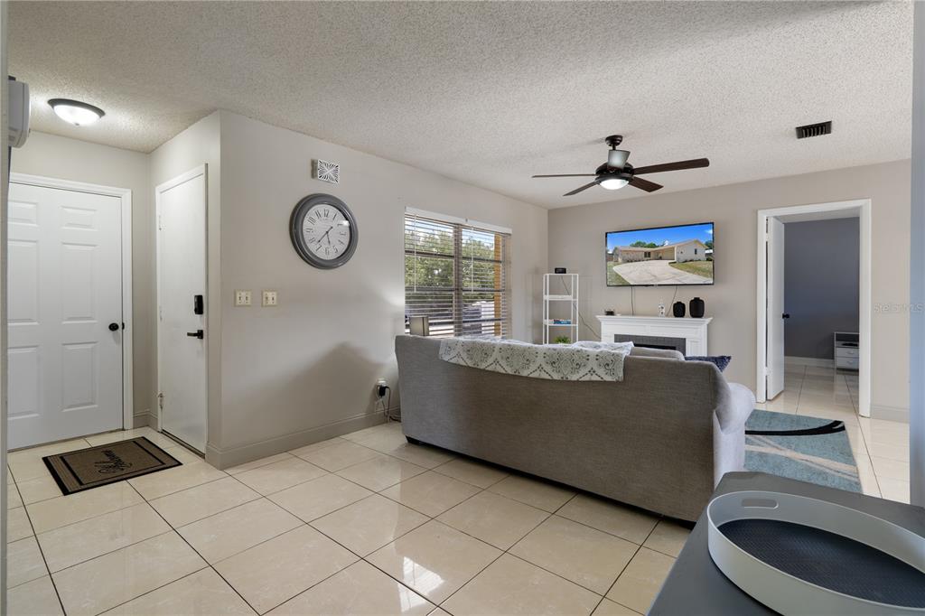 5025 Bromley Avenue Spring Hill, FL 34609 - Photo 7 of 41 a living room with a couch and a table