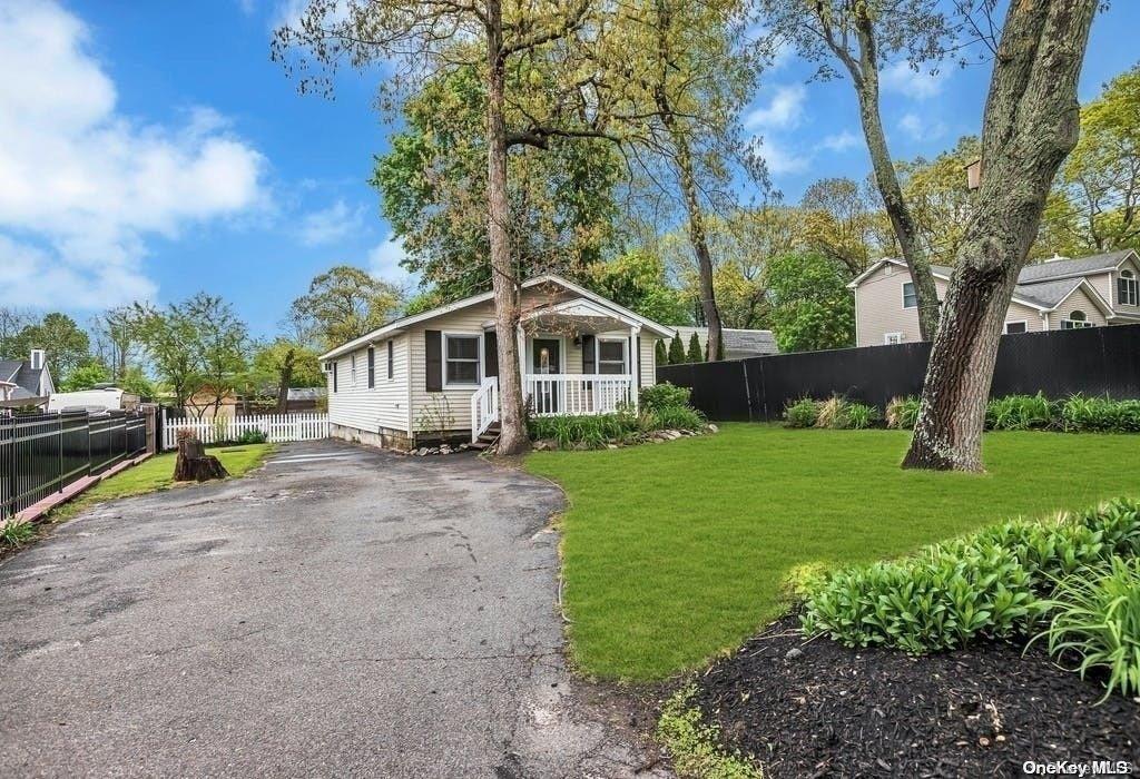 a view of a house with a yard patio and fire pit