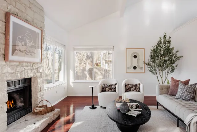 a living room with furniture and a fireplace