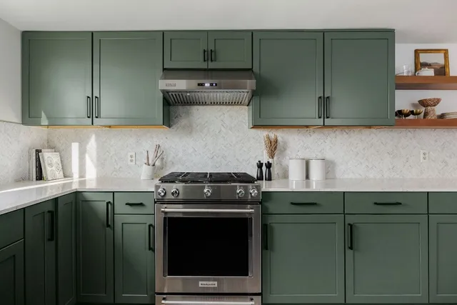 a kitchen with stainless steel appliances granite countertop a stove and a cabinets