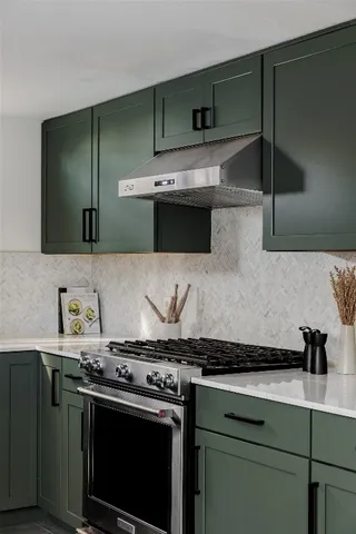 a kitchen with granite countertop a stove and a sink