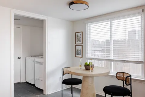a view of a livingroom with furniture and a window