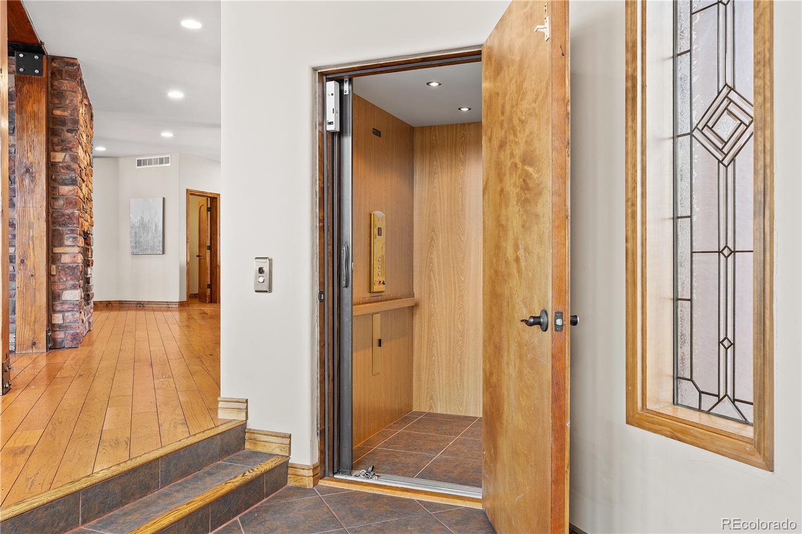 2505 Big Bear Circle Sedalia, CO 80135 - Photo 14 of 49 a view of a hallway with wooden floor and living room