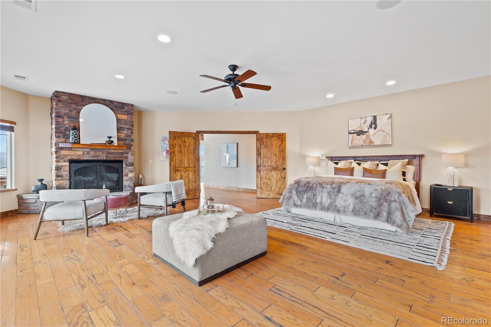 2505 Big Bear Circle Sedalia, CO 80135 - Photo 17 of 49 a living room with furniture a fireplace and a flat screen tv