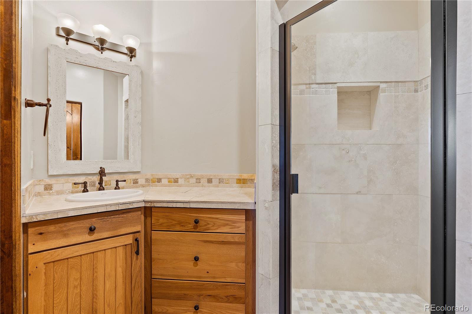 2505 Big Bear Circle Sedalia, CO 80135 - Photo 25 of 49 a bathroom with a sink and a mirror