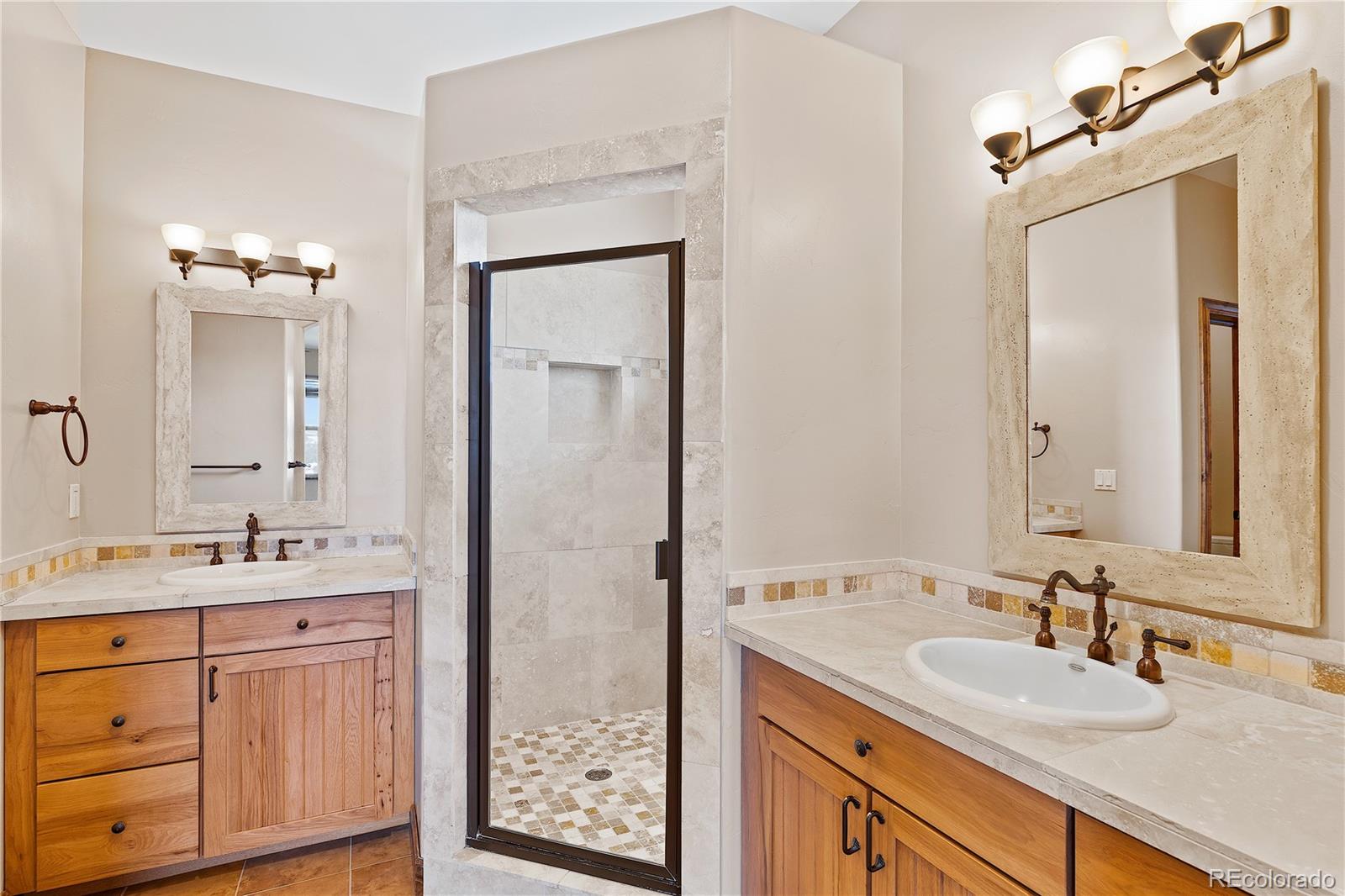2505 Big Bear Circle Sedalia, CO 80135 - Photo 27 of 49 a bathroom with a sink double vanity and a mirror