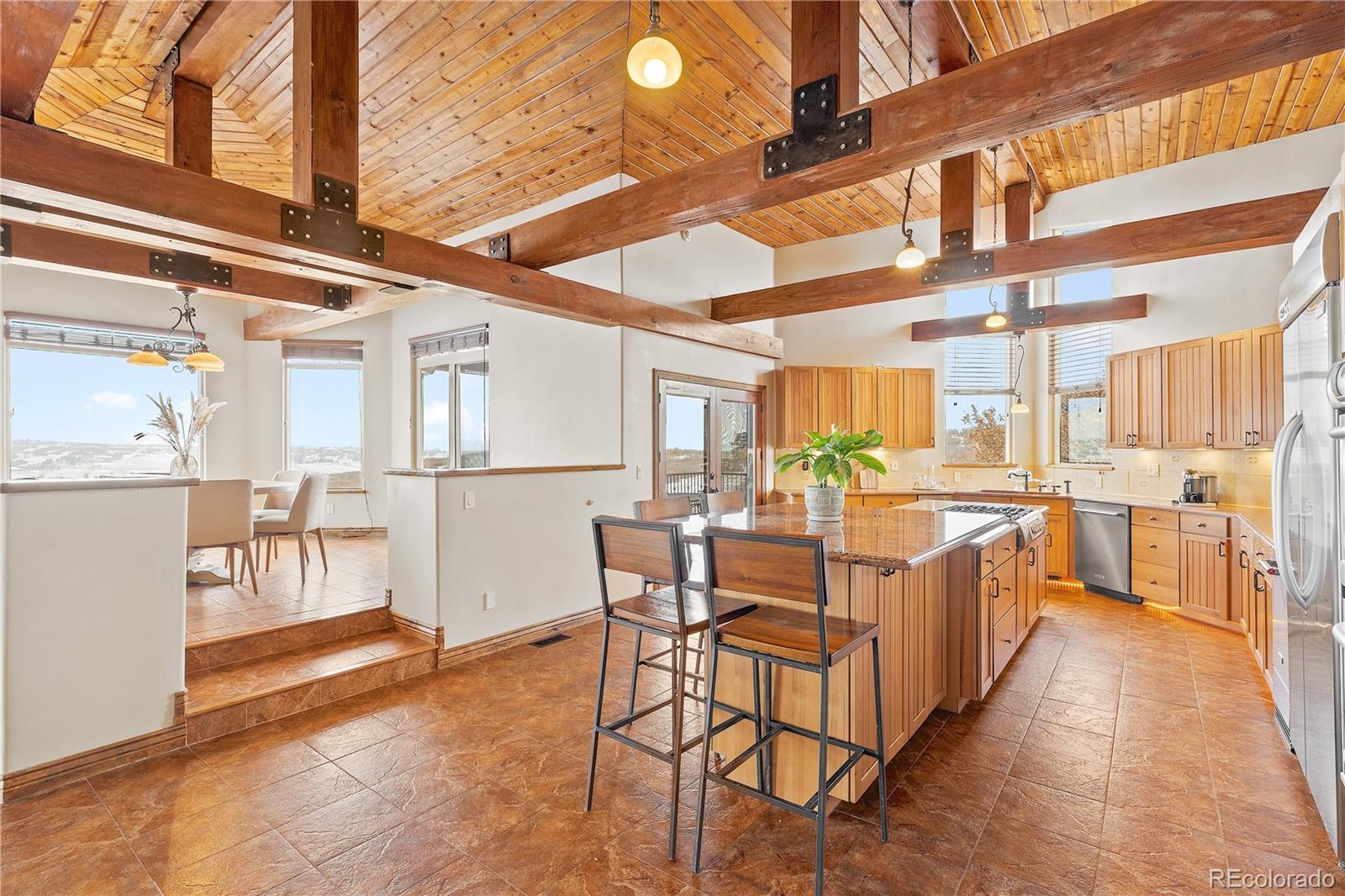 2505 Big Bear Circle Sedalia, CO 80135 - Photo 7 of 49 a view of a kitchen with kitchen island dining table and chairs