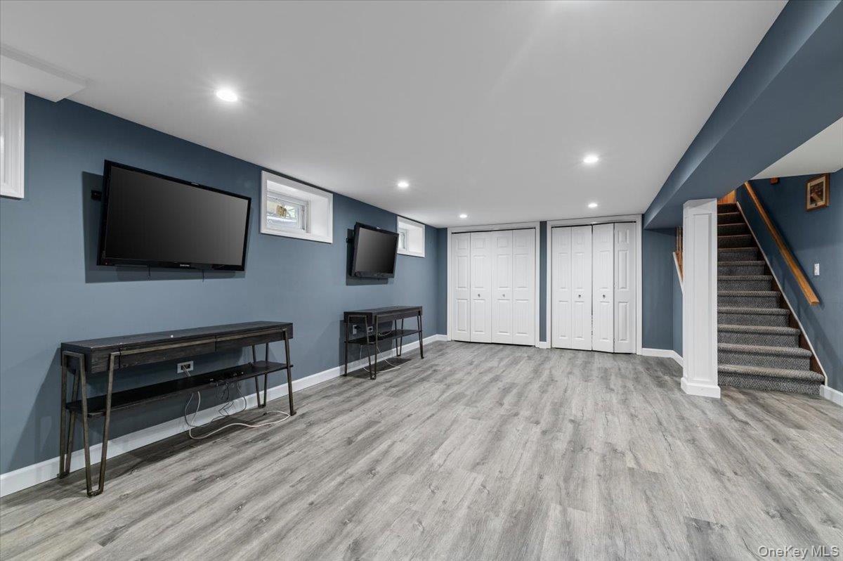 6 Apex Road Melville, NY 11747 - Photo 33 of 50 a view of a livingroom with furniture and flat screen tv