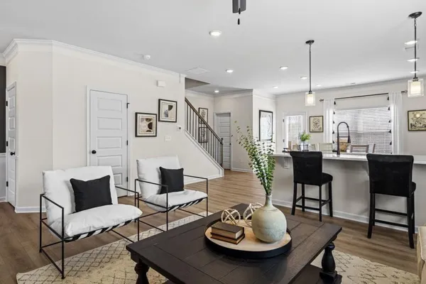 a living room with furniture kitchen view and a table
