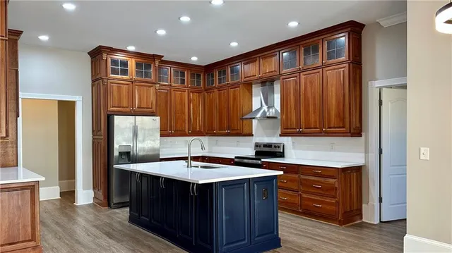 a kitchen with kitchen island granite countertop a sink and wooden cabinets