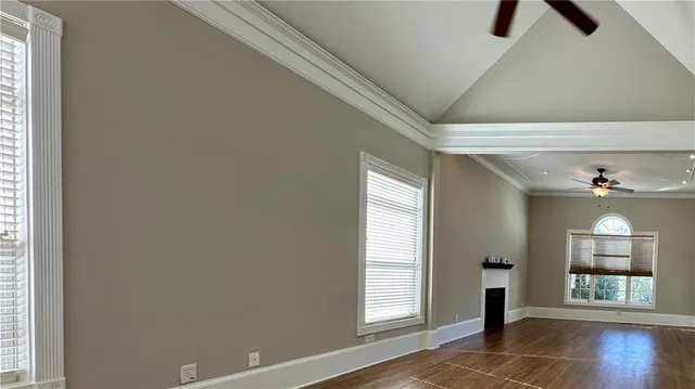 a view of hallway with wooden floor and chandelier