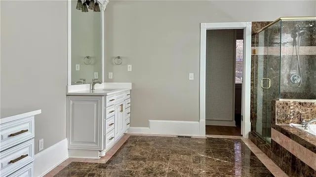a view of an empty room with wooden floor and window