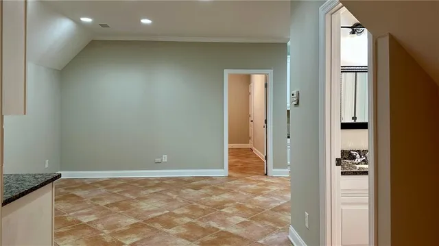 a view of a hallway with a chandelier fan