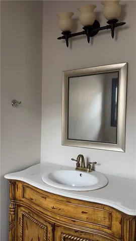 a view of a white house with a yard and potted plants