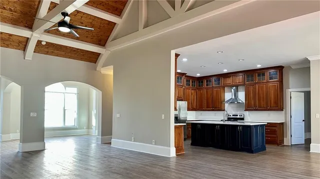 a view of kitchen with kitchen island microwave and cabinets