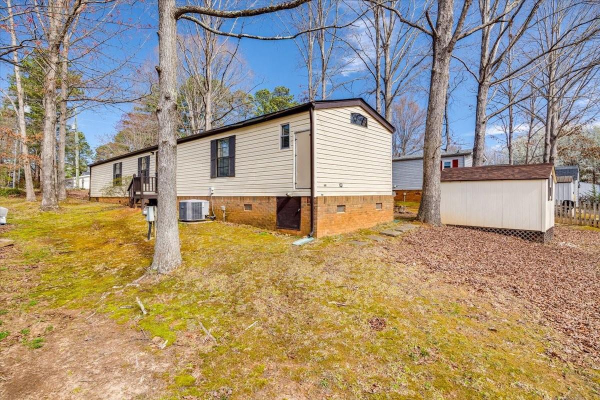 1230 Stateline Road Lake Wylie, SC 29710 - Photo 23 of 25 a view of a house with backyard and tree