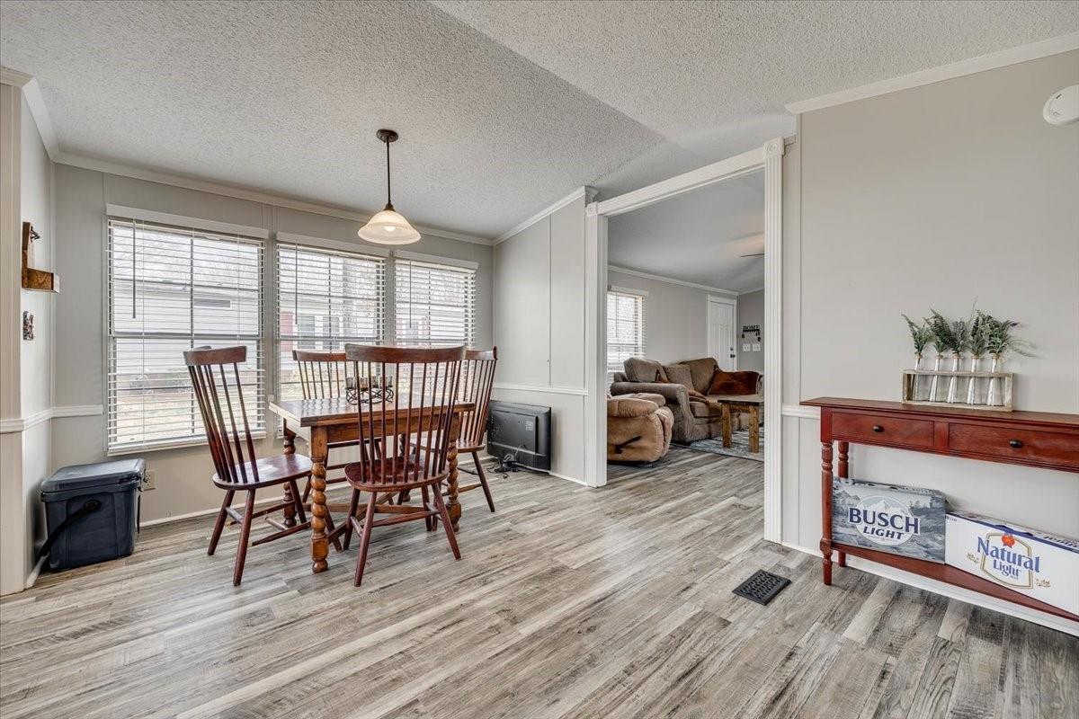 1230 Stateline Road Lake Wylie, SC 29710 - Photo 8 of 25 a view of a dining room with furniture window and wooden floor