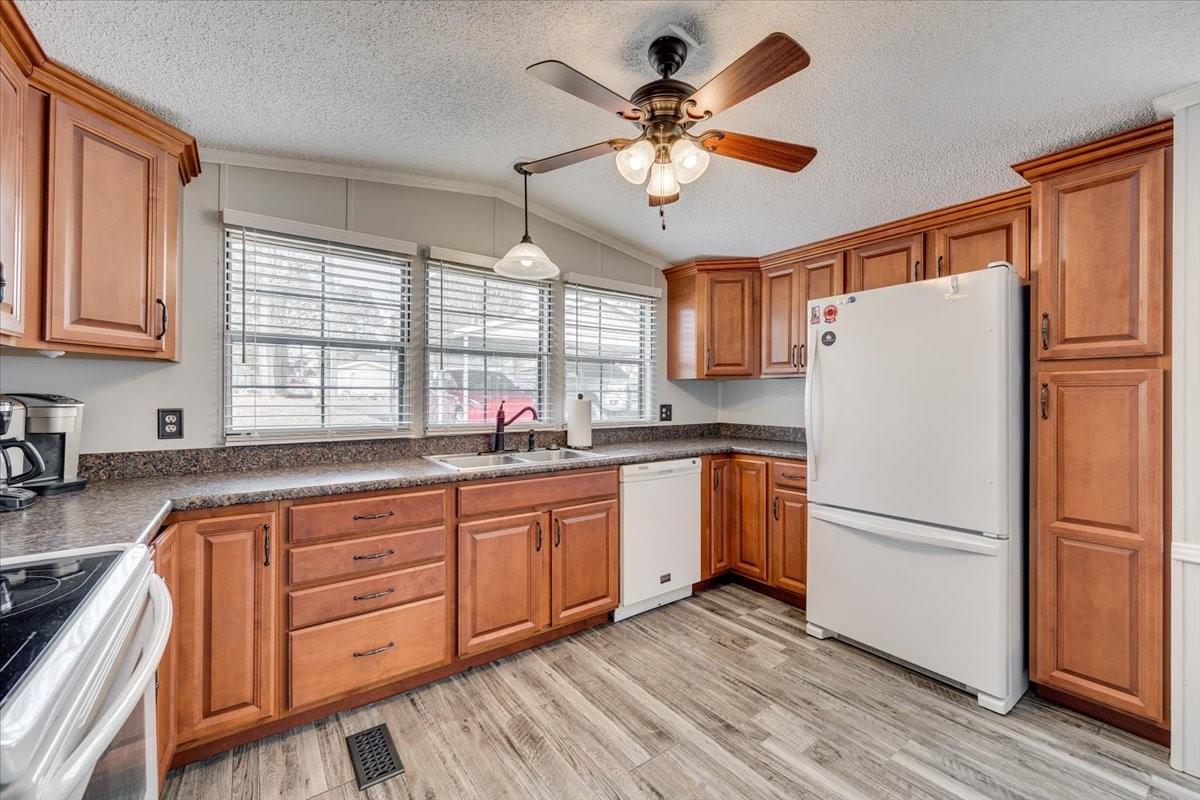 1230 Stateline Road Lake Wylie, SC 29710 - Photo 10 of 25 a kitchen with granite countertop stainless steel appliances a refrigerator cabinets and wooden floor