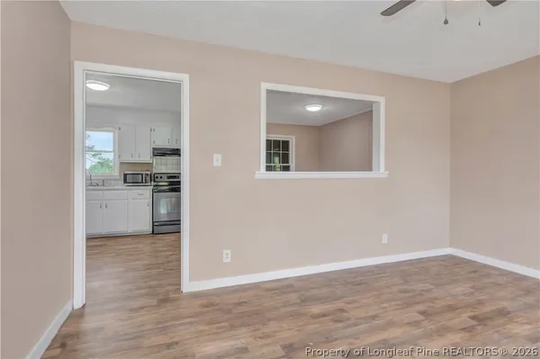 a view of a kitchen with a stove cabinets and wooden floor