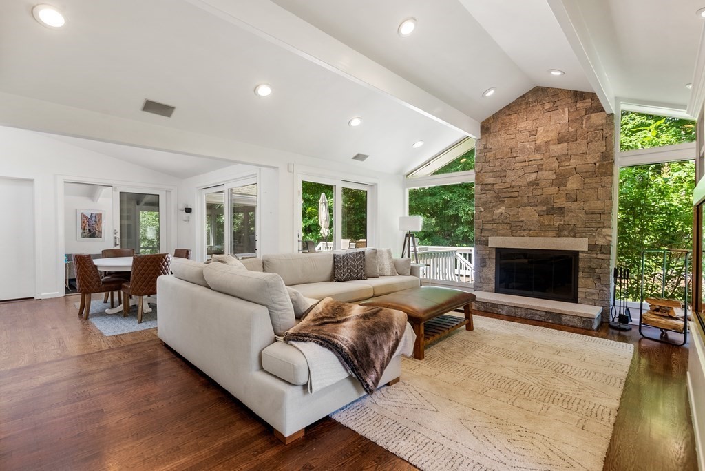 a living room with furniture large window and a fireplace