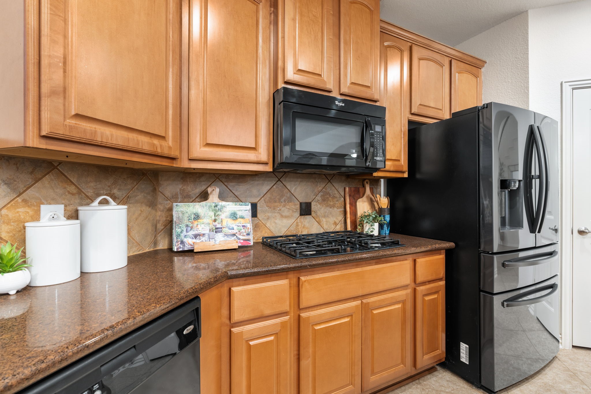 307 Arbor Ridge Lane Conroe, TX 77384 - Photo 15 of 50 a kitchen with stainless steel appliances granite countertop a refrigerator stove and microwave