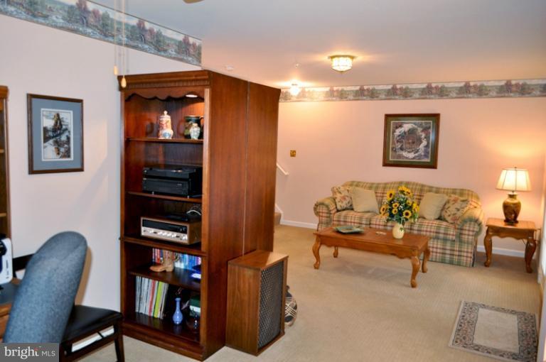 2233 Bear Den Road Frederick, MD 21701 - Photo 22 of 30 a view of a workspace with furniture and lamp on dresser