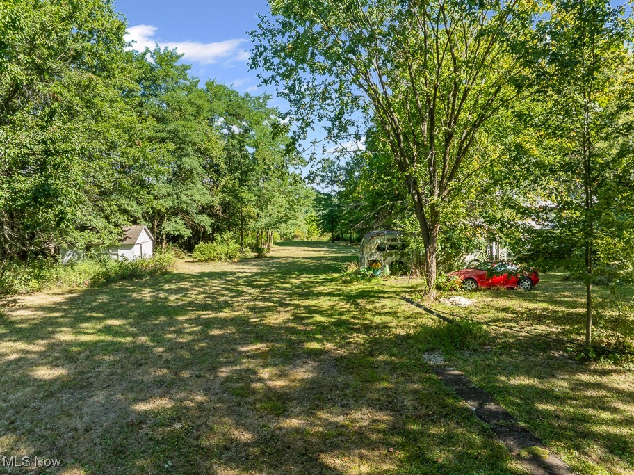 6727 Waterloo Road Atwater, OH 44201 - Photo 46 of 48 View of grassy yard featuring an outdoor structure and view of scattered trees