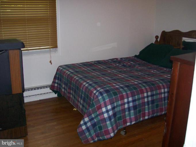 48420 Mattapany Road Lexington Park, MD 20653 - Photo 2 of 7 a bed sitting in a bedroom next to a window