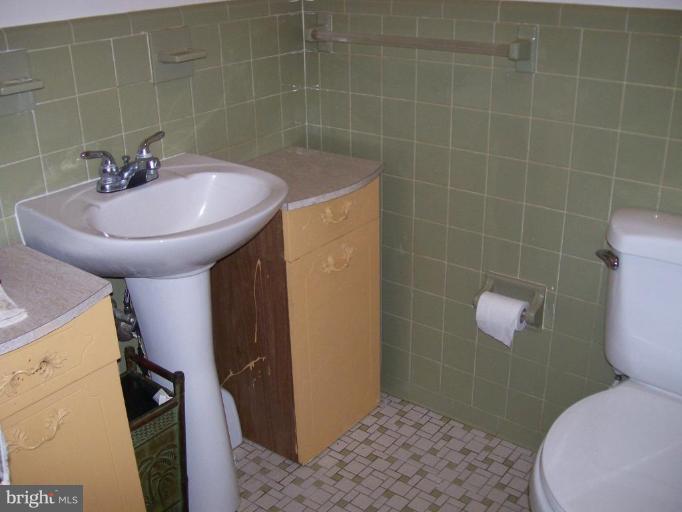 48420 Mattapany Road Lexington Park, MD 20653 - Photo 6 of 7 a bathroom with a sink toilet and shower