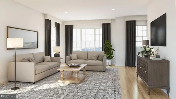 a living room with furniture and a large mirror next to a window