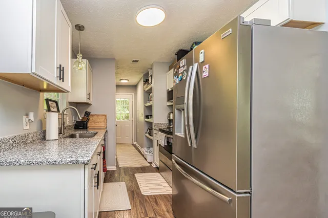 a white toilet sitting next to a white sink curtain