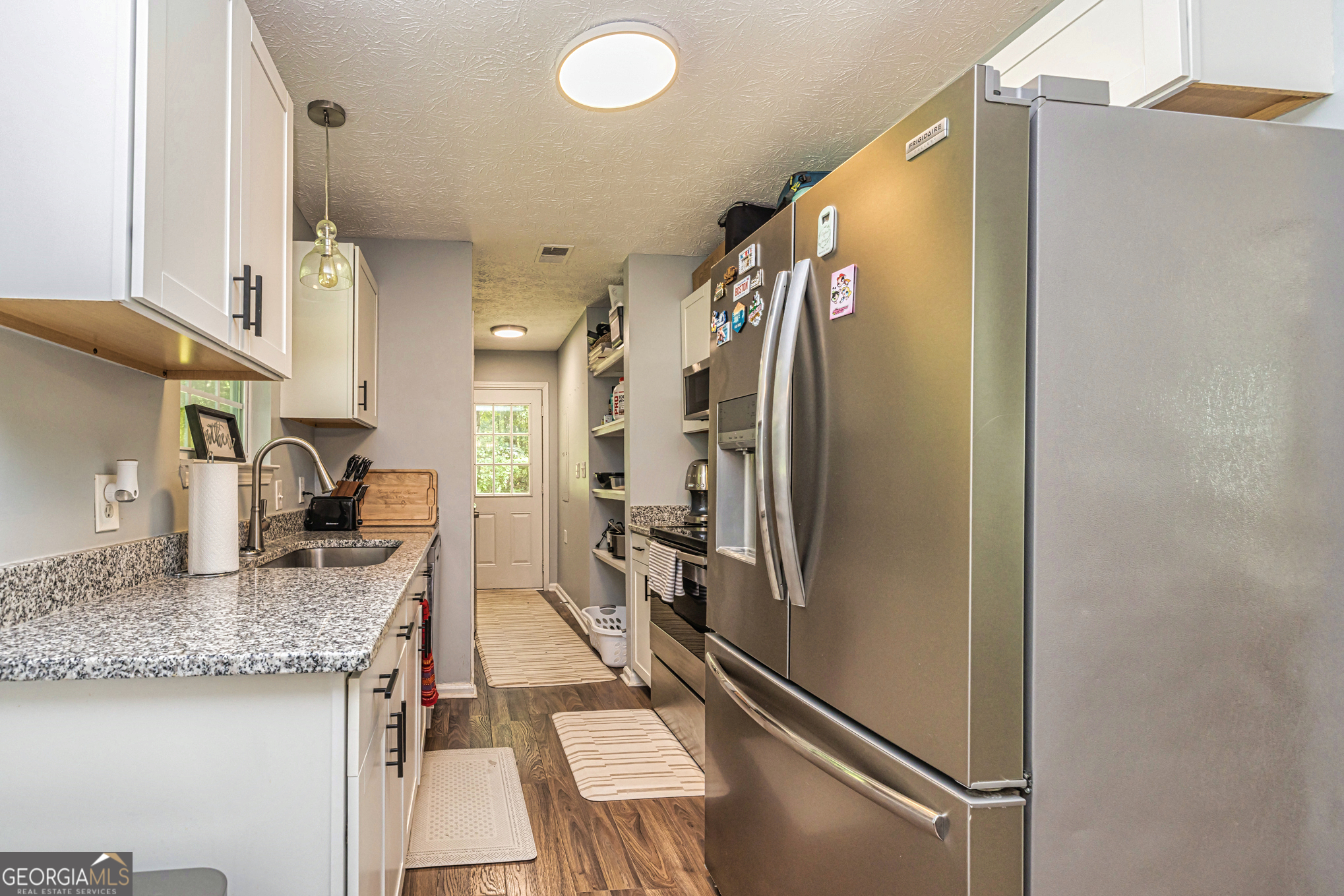 80 Prestigious Place Senoia, GA 30276 - Photo 12 of 19 a kitchen with stainless steel appliances granite countertop a refrigerator and a sink