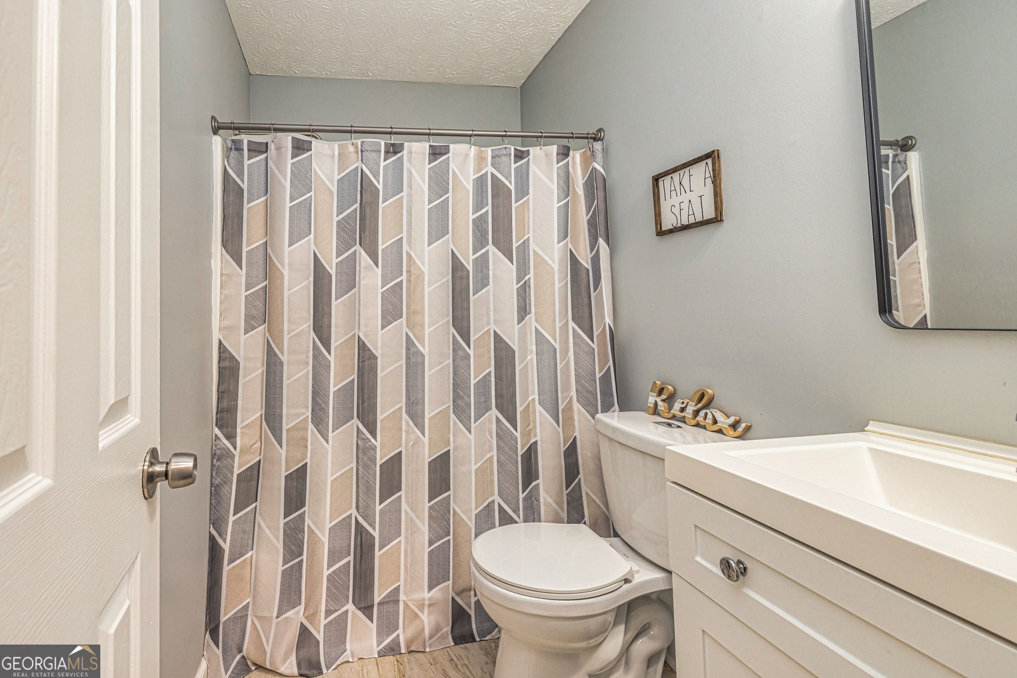 80 Prestigious Place Senoia, GA 30276 - Photo 13 of 19 a white toilet sitting next to a white sink curtain