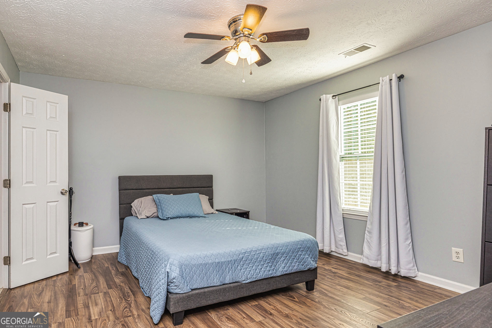 80 Prestigious Place Senoia, GA 30276 - Photo 15 of 19 a bedroom with a bed and a chandelier