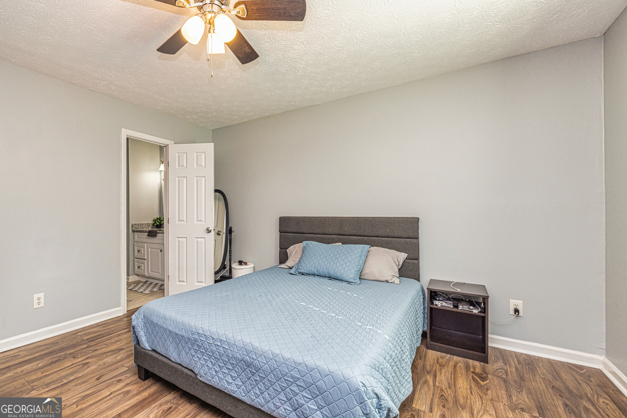 80 Prestigious Place Senoia, GA 30276 - Photo 16 of 19 a bedroom with a bed and a chandelier