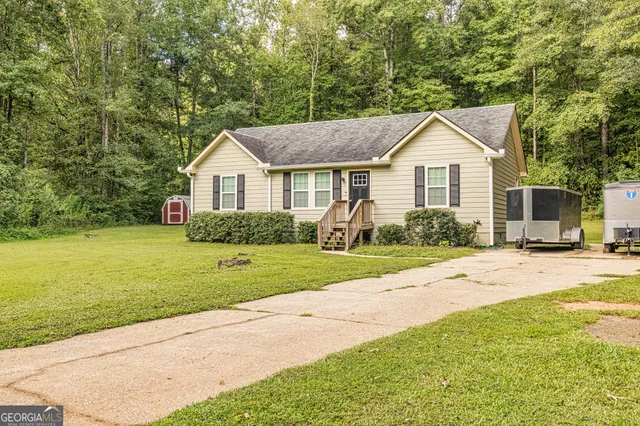 a front view of house with yard and green space