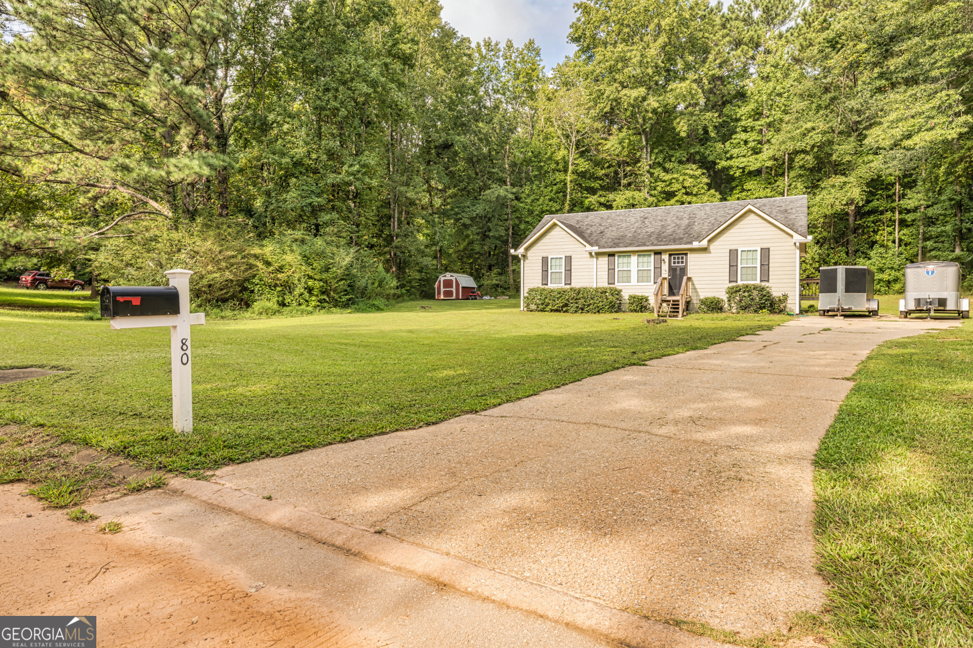 80 Prestigious Place Senoia, GA 30276 - Photo 3 of 19 a front view of a house with a yard and trees