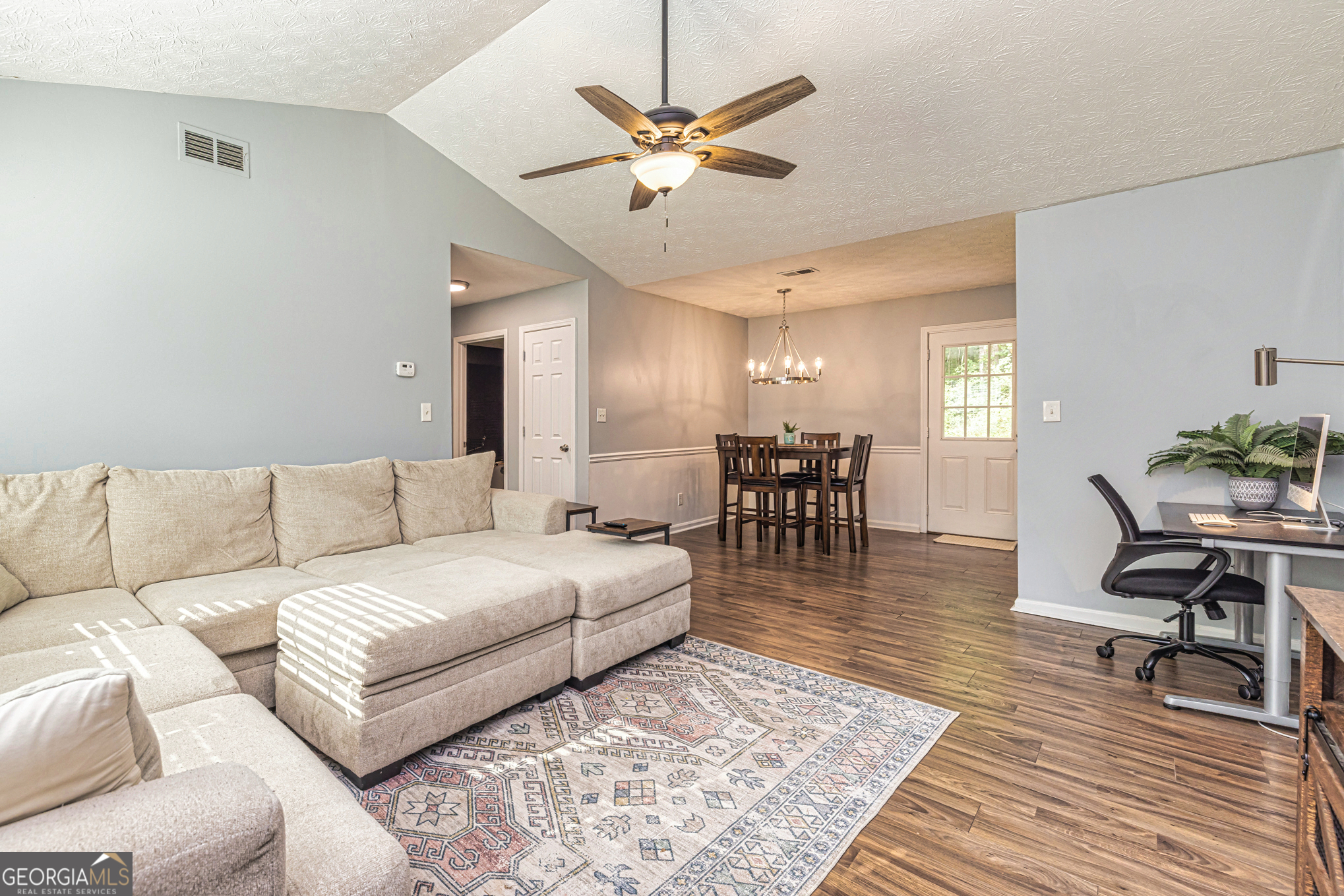 80 Prestigious Place Senoia, GA 30276 - Photo 8 of 19 a living room with furniture and a dining table with wooden floor