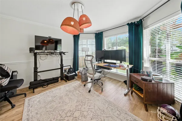 a view of a livingroom with workspace and a window