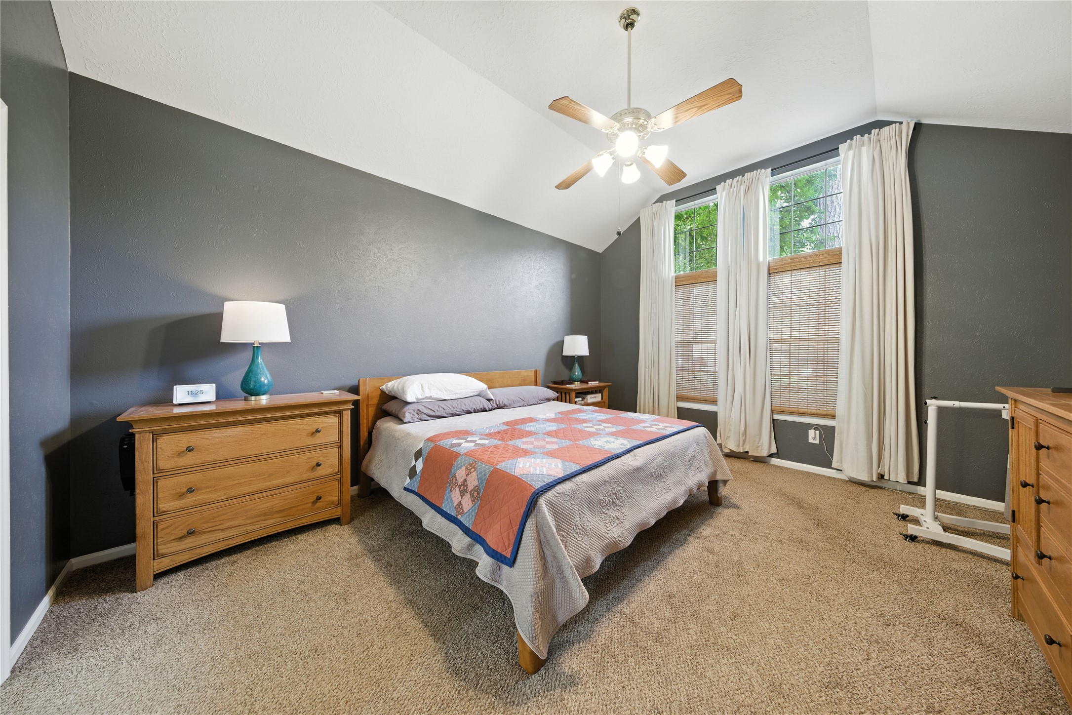 115 Regency Way Conroe, TX 77304 - Photo 15 of 32 a spacious bedroom with a bed and a chandelier