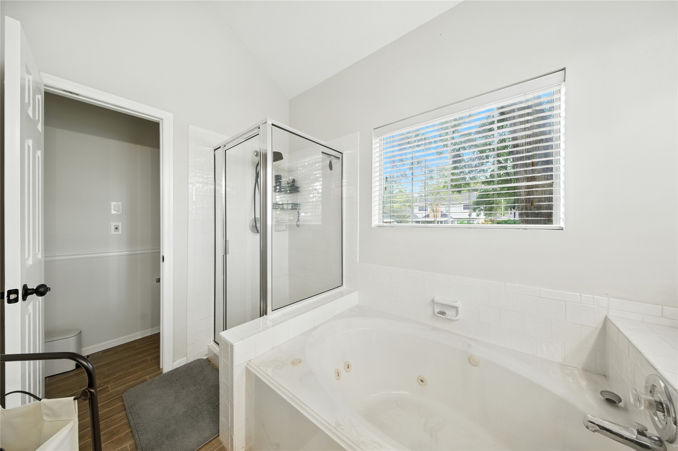 115 Regency Way Conroe, TX 77304 - Photo 18 of 32 a bathroom with a bathtub and a shower