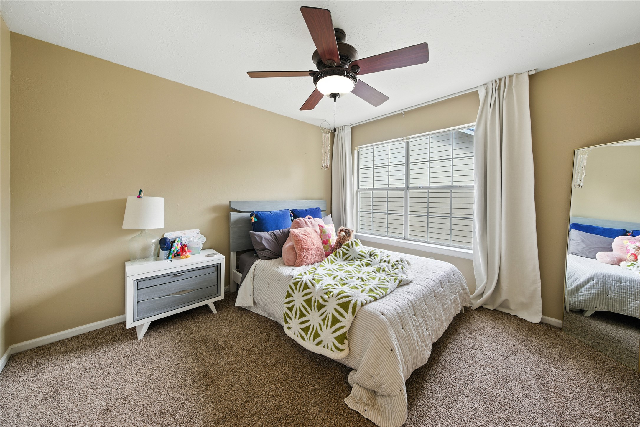 115 Regency Way Conroe, TX 77304 - Photo 25 of 32 a bed room with a bed and a window
